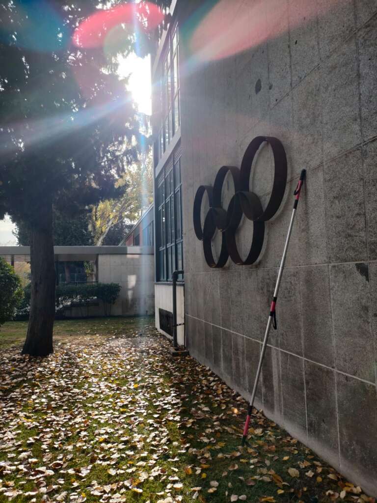 foto 4: fotografía que muestra los aros olímpicos con una barra direccional apoyada horizontalmente sobre el muro en el que se sitúan los aros olímpicos.